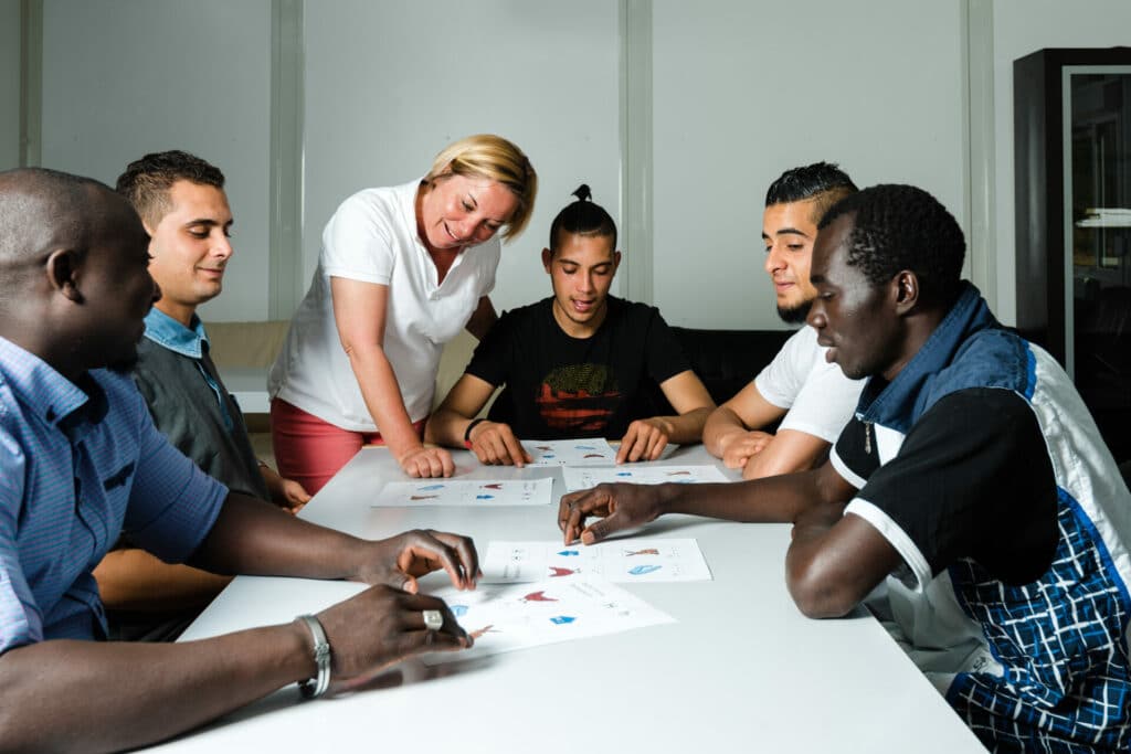 A group of students studying with a teacher