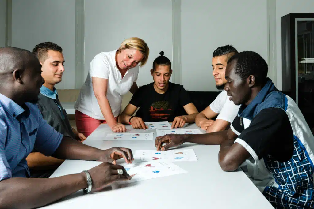 A group of students studying with a teacher