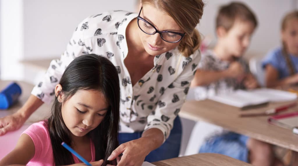 A TEFL teacher helping a student in class