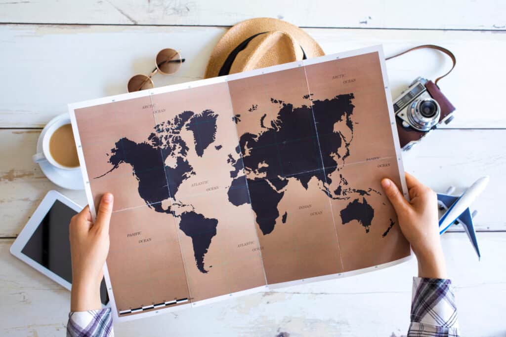 Travelling along as a woman: is it safe? Woman looks at map deciding where to go.