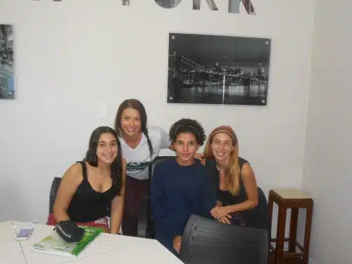 TTA alumna Rosie with three students in a classroom in Brazil